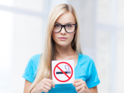 Woman holding no smoking sign